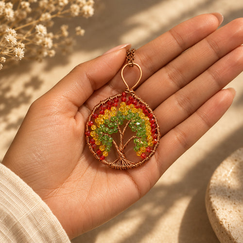 Alchemy Flame Canadian autumn inspired Tree of Life pendant displayed in hand