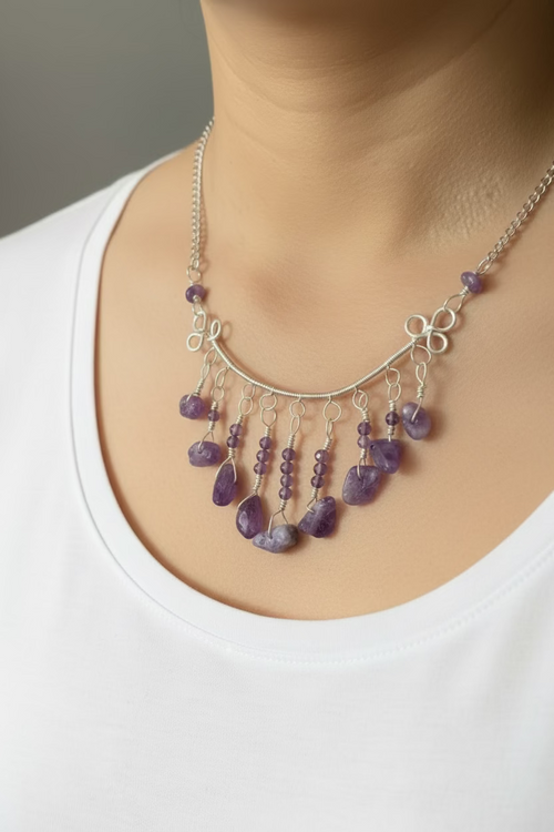 Model wearing handcrafted Amethyst Moonfall Necklace featuring cascading amethyst gemstone drops and silver-toned wirework.