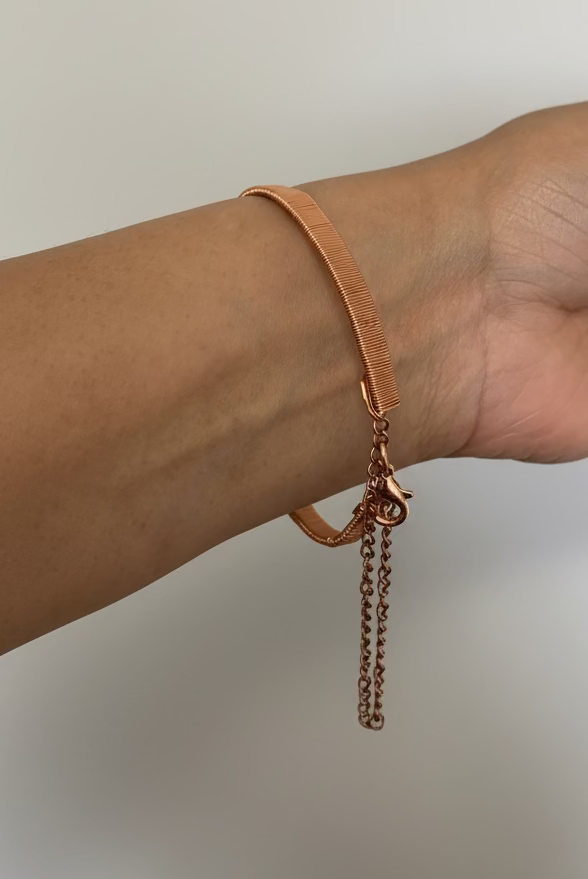 Back side of artisan handcrafted copper cuff bracelet with mystic aura quartz.