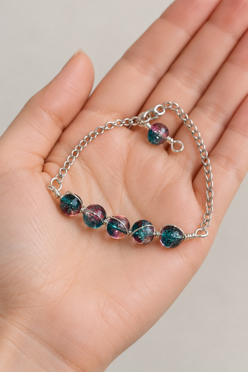 Aurora Kiss handmade teal and pink dual-colour glass bead bracelet in silver-toned copper wire.