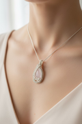 Model wearing the handcrafted Blushing Moon Pendant featuring a natural Rose Quartz surrounded by Moonstones wrapped in silver-toned copper wire.