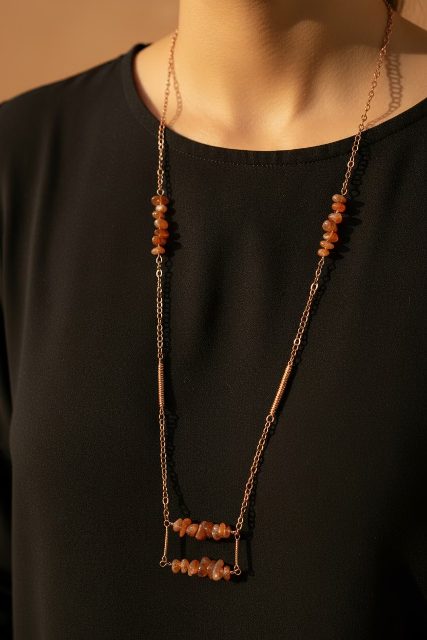 Model wearing Canyon Glow, a handmade long copper necklace featuring natural orange Carnelian gemstone chips and artisan wire-wrapped details.