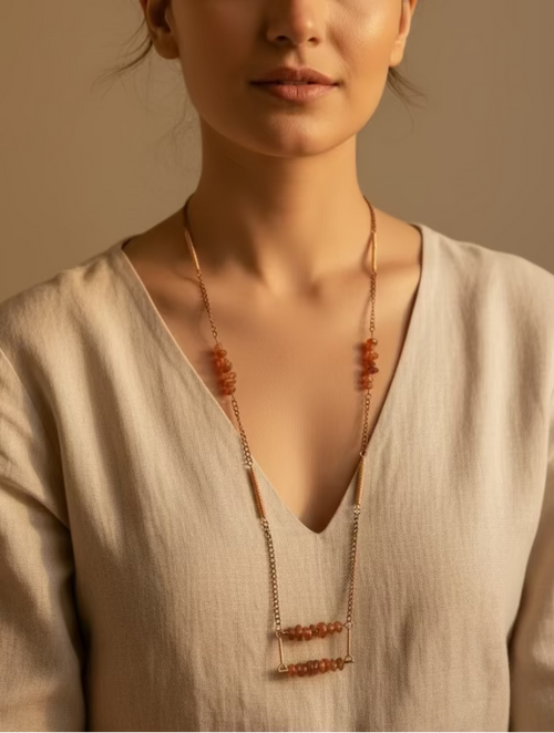 Model wearing Canyon Glow, a handmade long copper necklace featuring natural orange Carnelian gemstone chips and artisan wire-wrapped details.