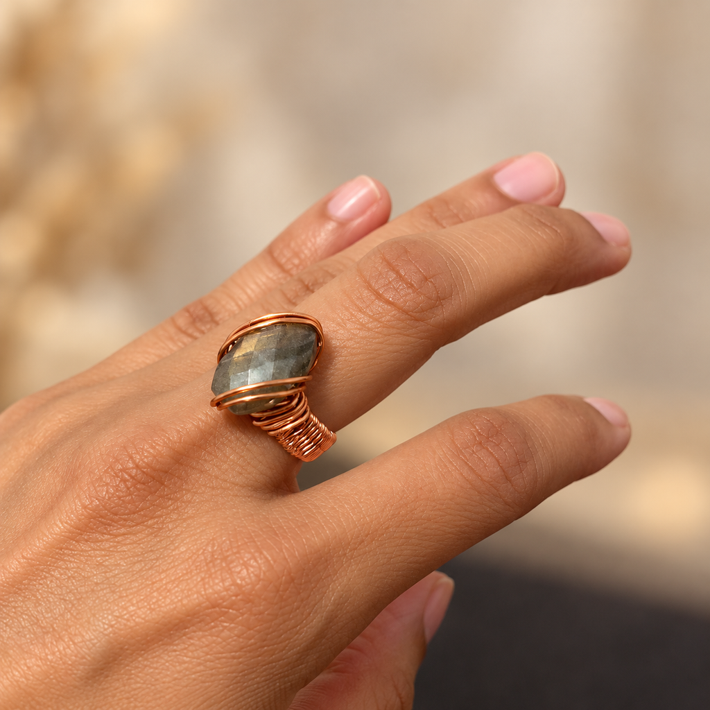 Charming Labradorite handmade copper wire ring with a 10 × 14 mm faceted stone, worn on a hand.