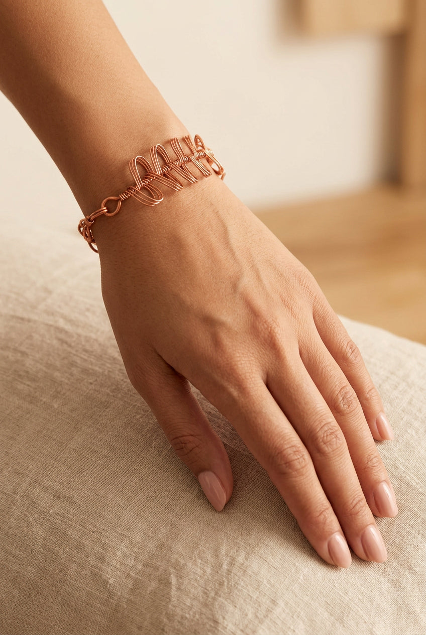 Copper Rhapsody sculptural copper wire bracelet worn on the wrist, showcasing its end lock.