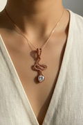 Handwoven Copper Tie pendant featuring an 8 mm zirconia displayed on a model wearing a cream blouse.