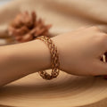 copper bracelet with intrinsic weaving pattern is being showcased in model wrist.