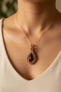 Woman wearing the Cosmic Bloom handmade Blue Goldstone pendant wrapped in polished copper wire with a floral-inspired artisan design.