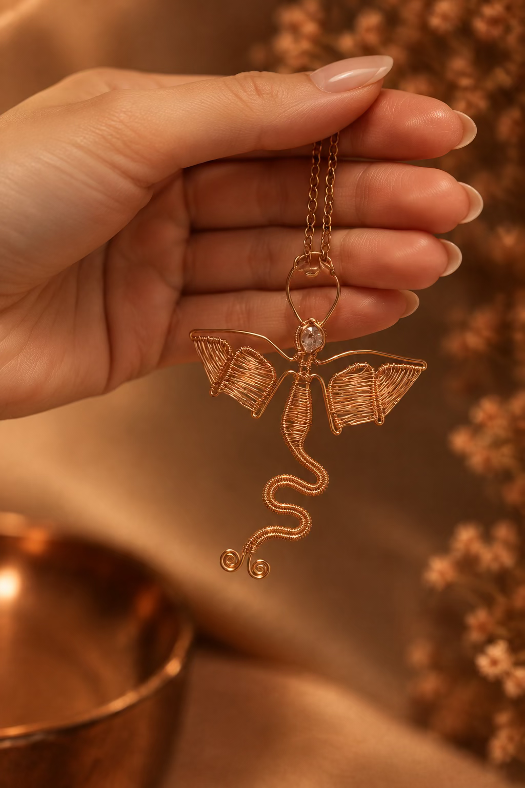Hand holding handcrafted copper Dragon Heart pendant