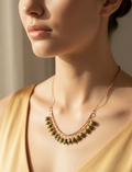Model wearing the Evergreen Grace handcrafted unakite and copper necklace, showcasing the elegant crescent design with genuine green gemstone beads.
