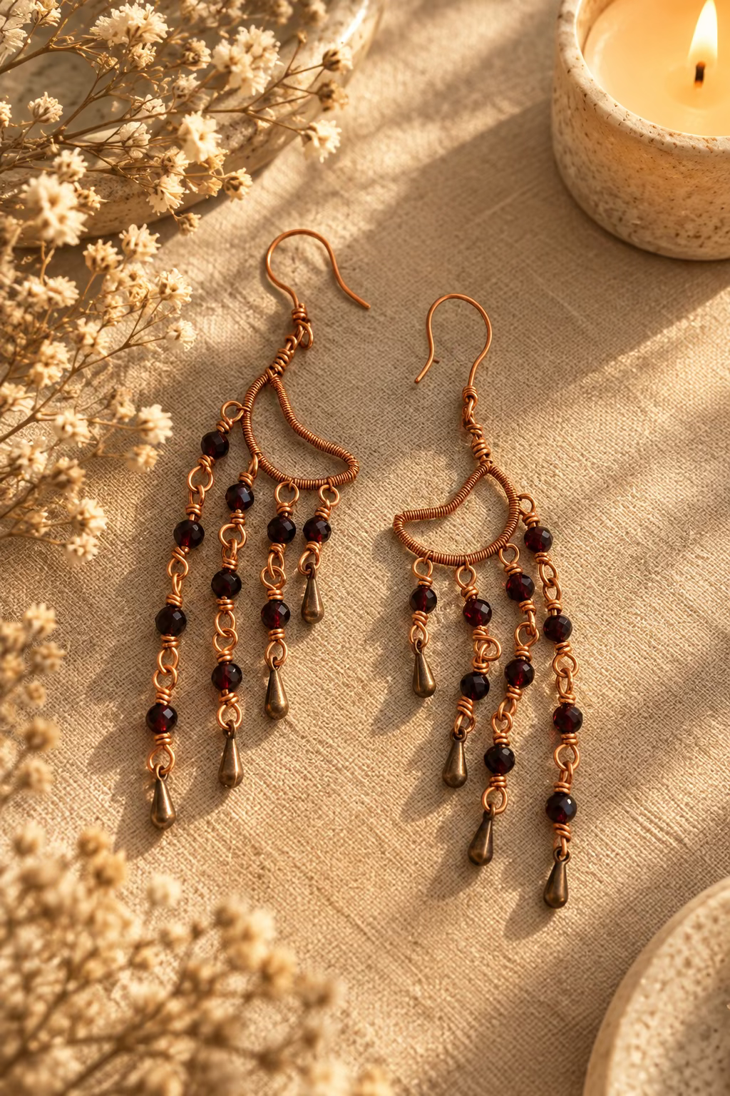 Pair of handcrafted Garnet Alchemy Cascade Earrings with red garnet beads, intricate copper wire wrapping, and dangling copper teardrops.