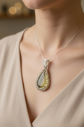 Model wearing Golden Serenity Pendant featuring a handcrafted golden resin centerpiece wrapped in silver-toned wire.