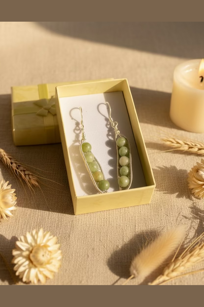 Handmade Green China Jade Peapod earrings wrapped in silver-toned copper wire inspired by nature.