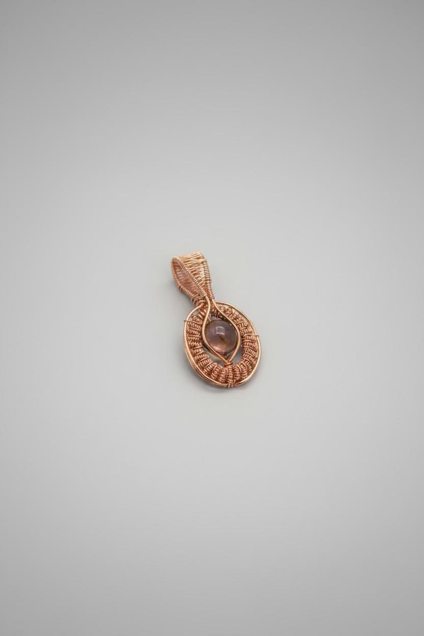 A copper wire-wrapped pendant with a mystic aura quartz