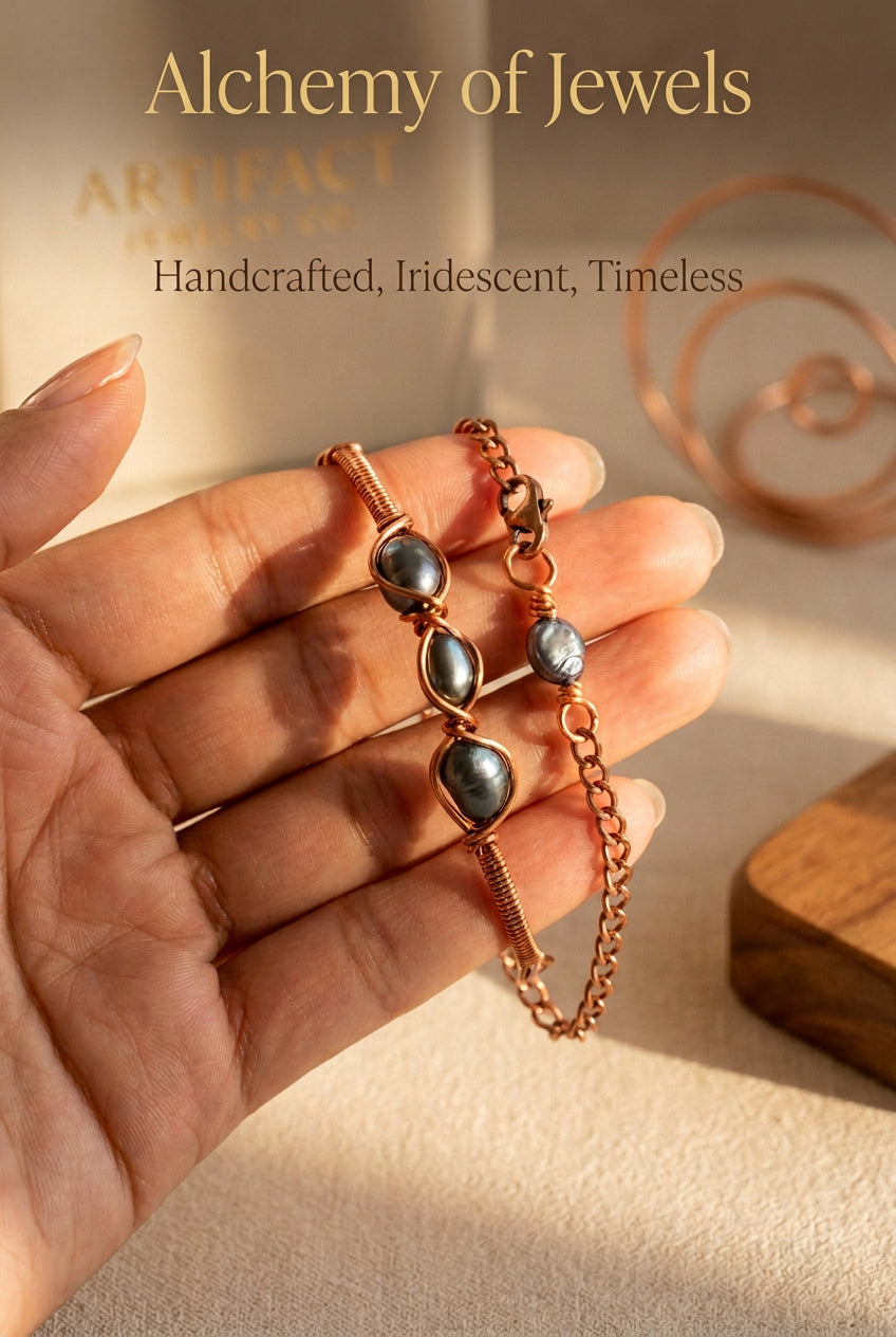 Pearl Alchemy bracelet with three dark grey pearls wrapped in copper wire and finished with a copper chain closure.