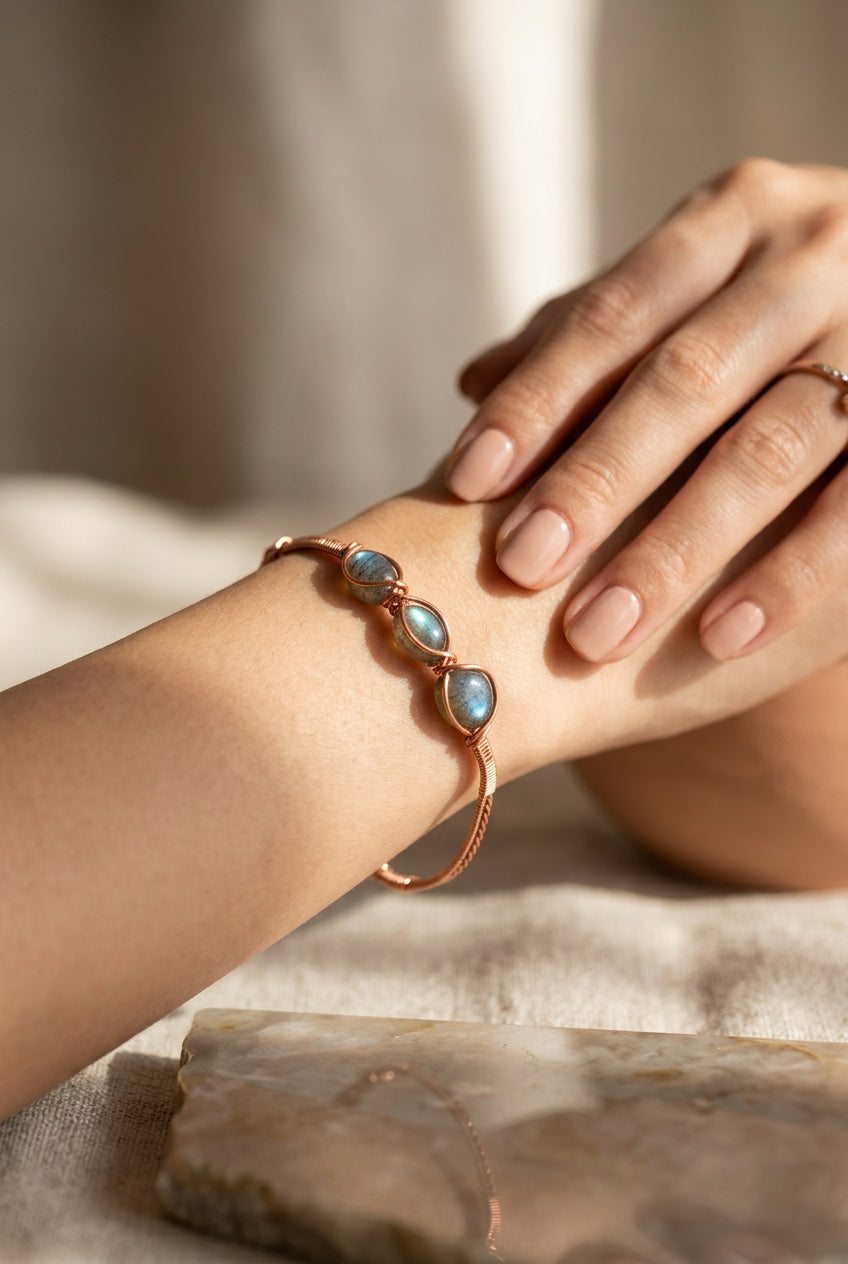 Pearl Alchemy bracelet with three dark blue/grey pearls wrapped in copper wire and finished with a copper chain closure.
