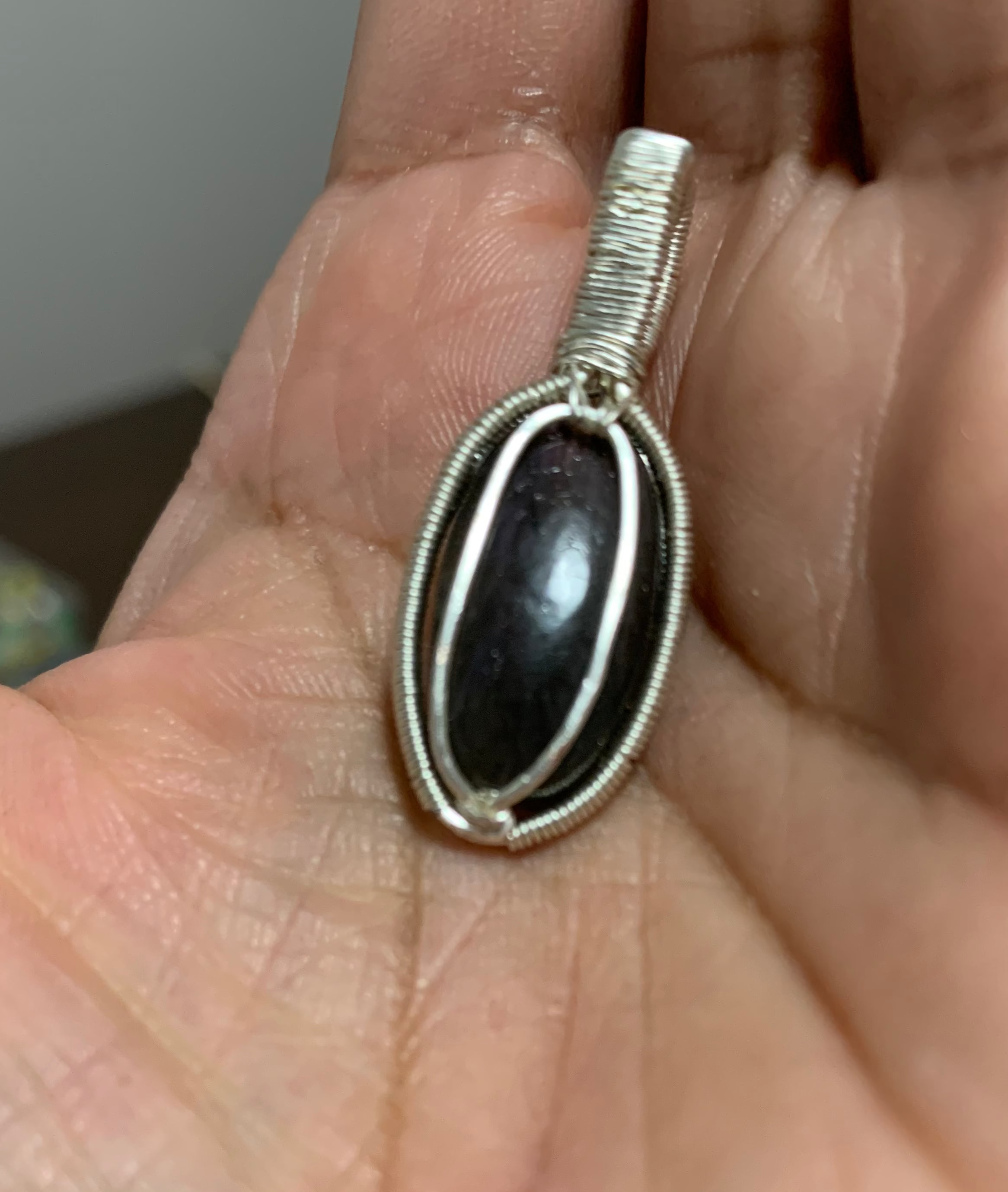 Handcrafted Twilight Aura labradorite pendant with violet flash in silver-toned copper wire wrapping.