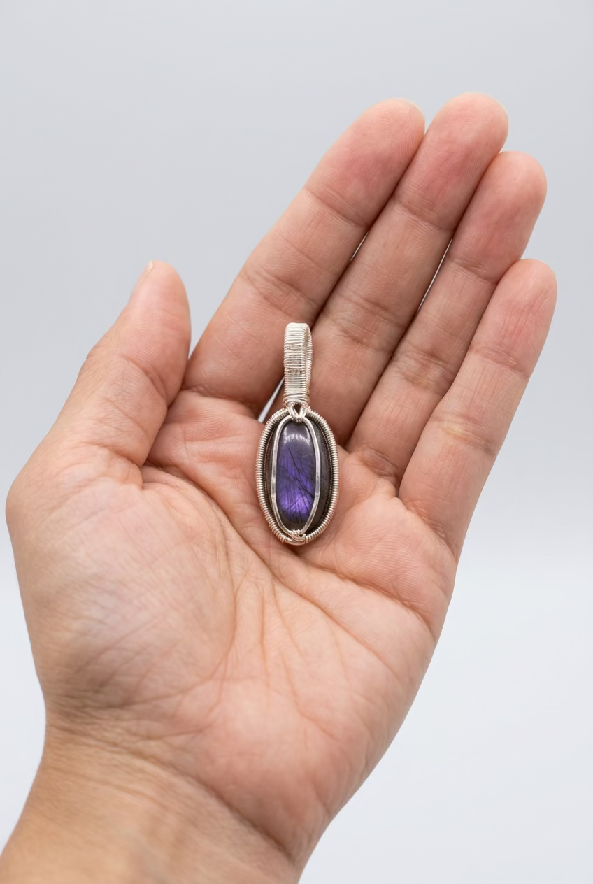 Handcrafted Twilight Aura labradorite pendant with violet flash in silver-toned copper wire wrapping.