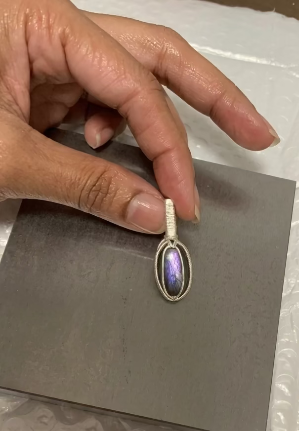 Handcrafted Twilight Aura labradorite pendant with violet flash in silver-toned copper wire wrapping.