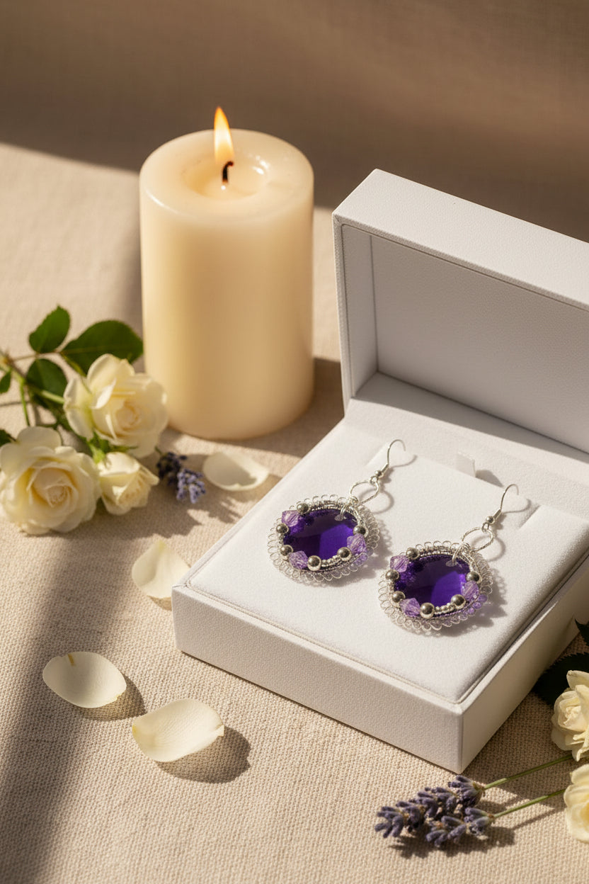 Velvet Violet Lace Earrings displayed in a gift box with candle and floral accents.