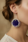 Woman wearing handmade Velvet Violet Lace Earrings featuring dark purple resin and silver-toned copper wire.