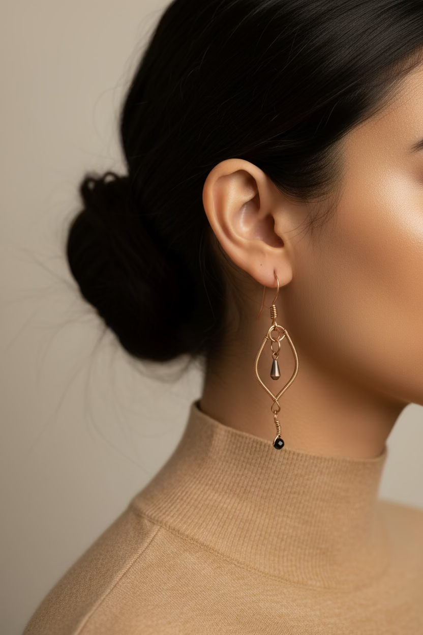 Woman wearing Verdant Whisper handcrafted copper earrings featuring faceted malachite stones and suspended copper accents in an elegant marquise design.