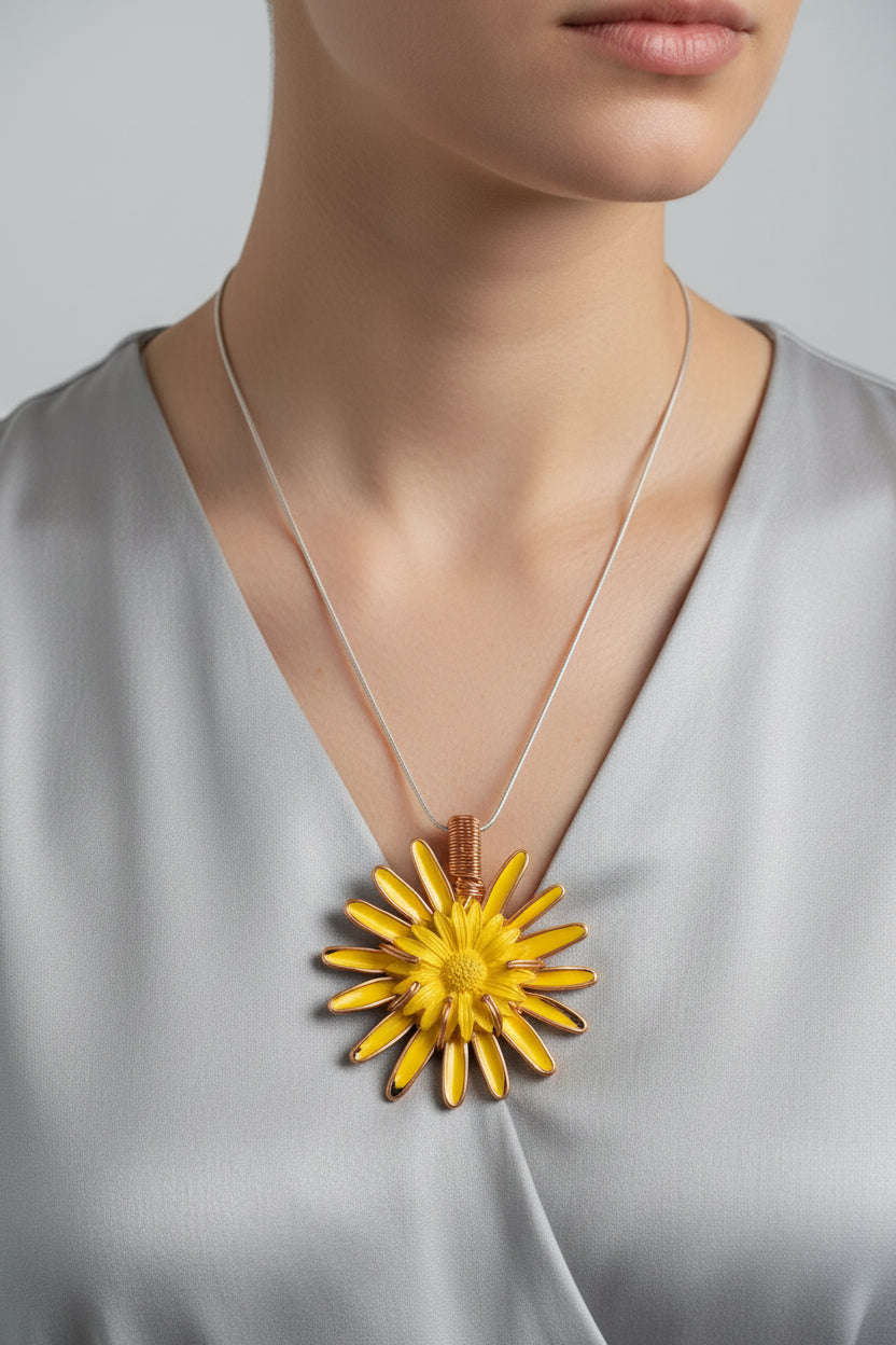 Necklace with a yellow flower pendant on a grey dress