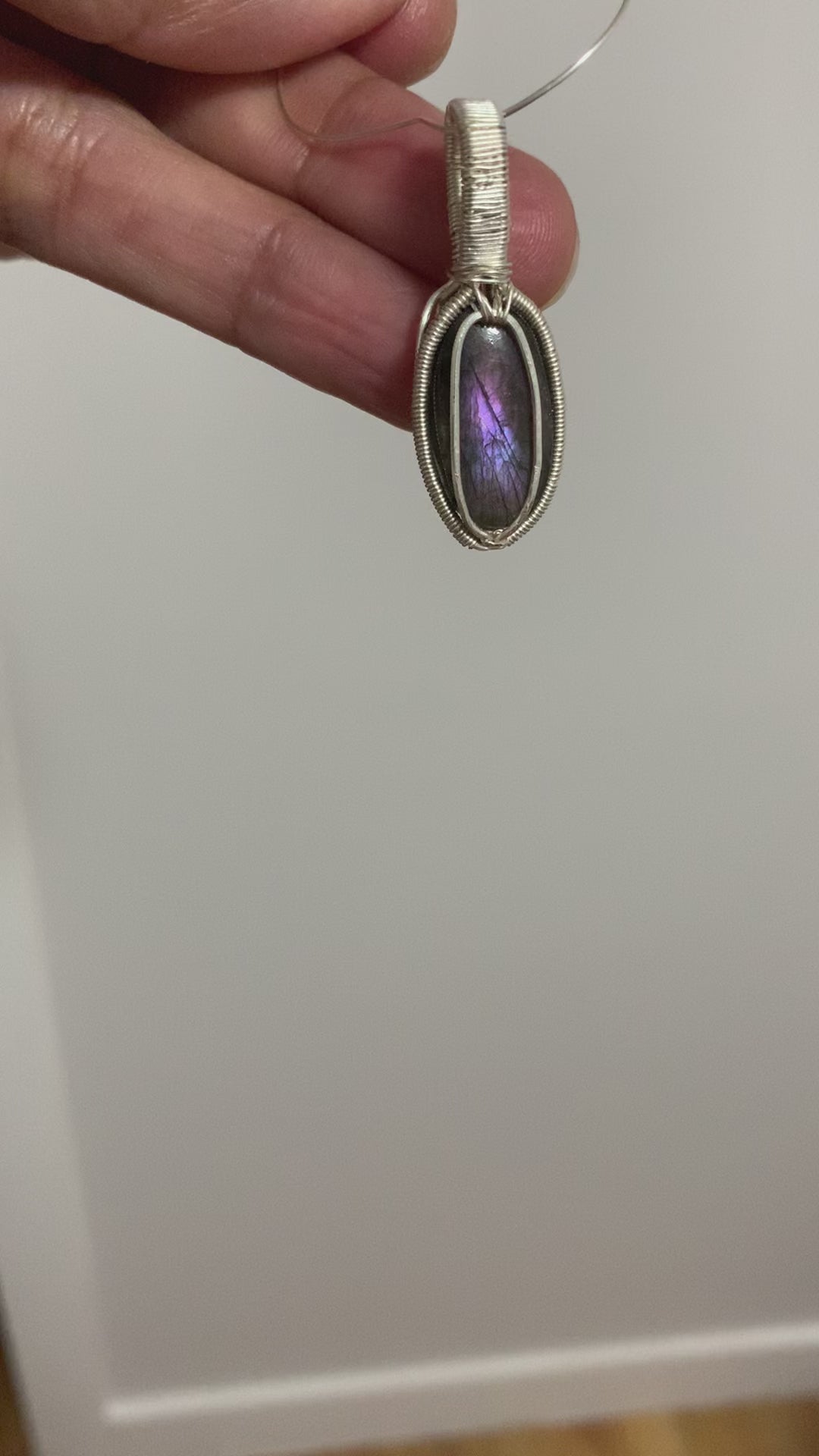 Handcrafted Twilight Aura labradorite pendant with violet flash in silver-toned copper wire wrapping.